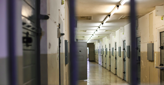 pretrial detention jail corridor showing isolation cells and controlled environment conditions